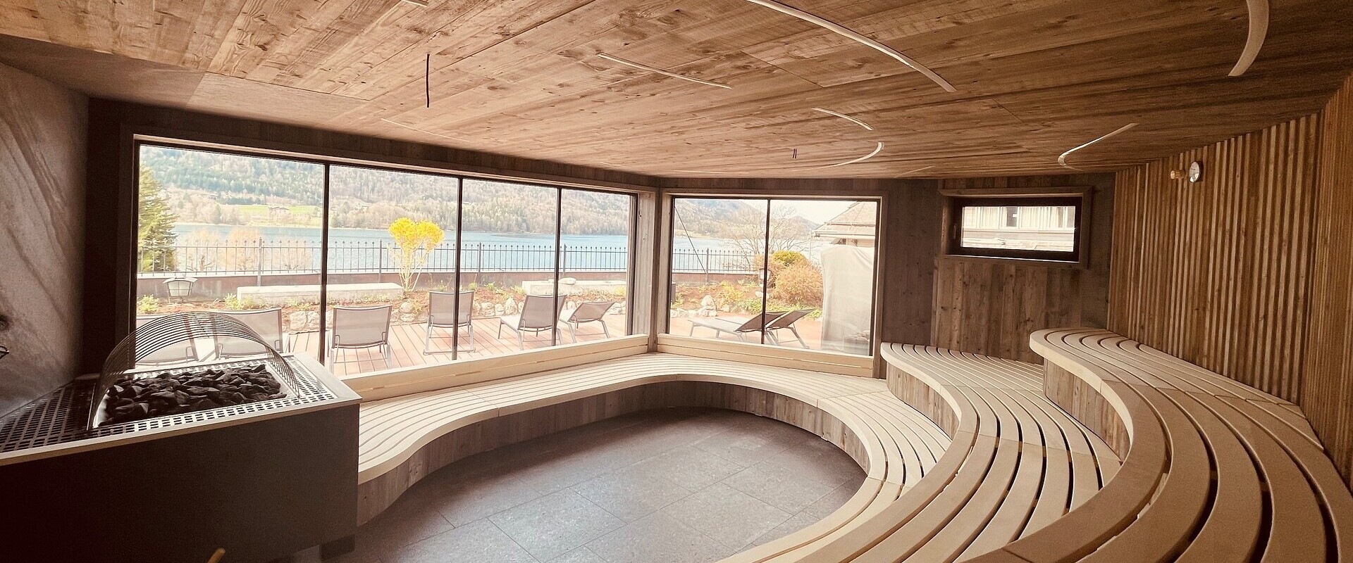 Wellness pur im Wellnesshotel Ebner's Waldhof am Fuschlsee. Pärchen beim Aufguss in der Sauna.