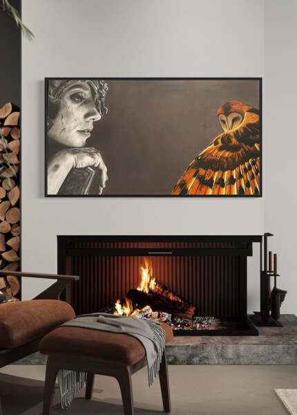 A cozy living room with a modern fireplace, art featuring a woman and an owl, and a comfortable chair with a footrest.