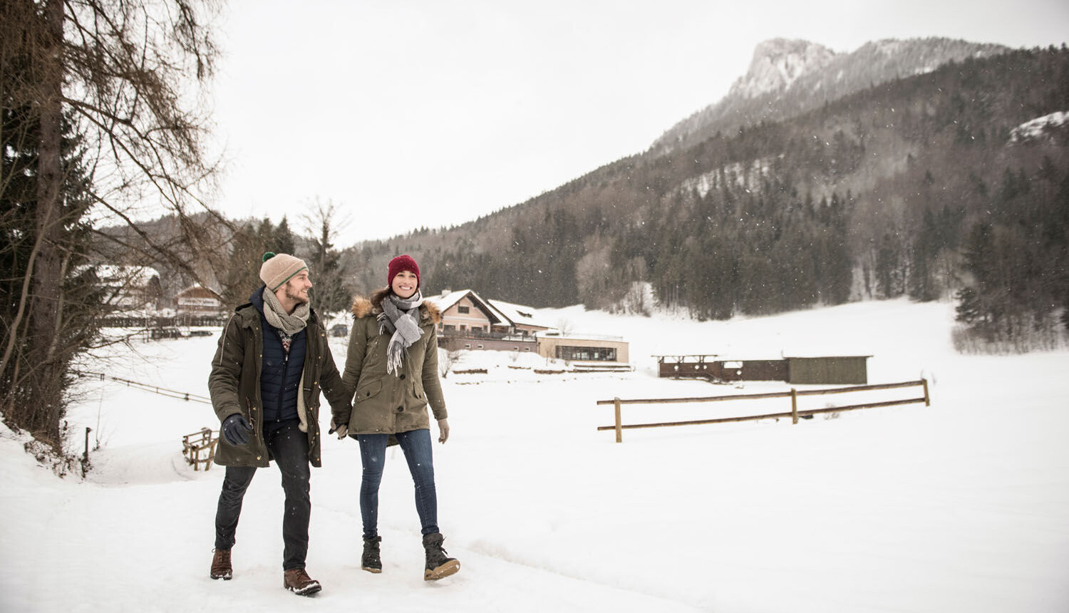 Pärchen in der Wiese liegend auf einer Alm im Aktivurlaub am Fuschlsee, Salzburg.