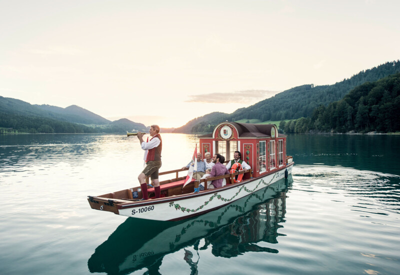 Eine Zille mit Bläser am Fuschlsee, Salzkammergut.